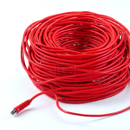 Neat coil of red audio cable with a jack plug against a clean white backdrop