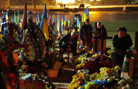 Photo for Lviv, Ukraine, 1 November 2022. Ukrainians light candles while visiting the graves of Ukrainian soldiers who died in the war with Russia marking All Saints' Day and All Souls' Day at the Lychakiv Cemetery in Lviv,. Russia invaded Ukraine on 24 Februa - Royalty Free Image