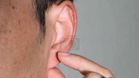 Person pressing ear points
