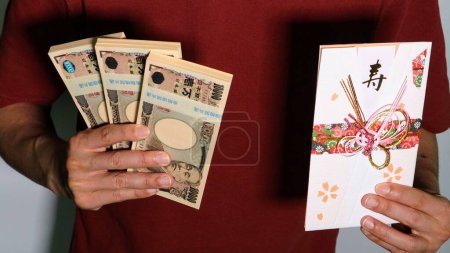 Photo for Businessman with gift bag and wad of money - Royalty Free Image