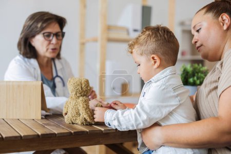 Photo for Caucasian curvy mother with her son visit pediatrician in hospital.consultation with female doctor Child care, healthcare, medicine concept. - Royalty Free Image