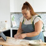curvy woman following online recipe on her digital tablet
