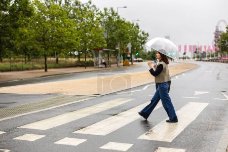 Photo for Asian woman crossing pedestrian crossing - Royalty Free Image
