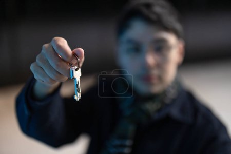 Photo for Closeup of male hands holding keys to new house - real estate, housing and people concept - Royalty Free Image