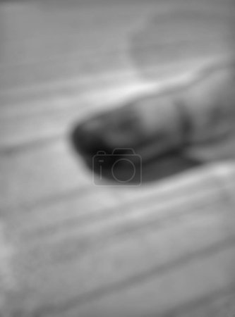 Portrait, close-up of the little finger or Kelingking hand gesture after the vote. Indonesian presidential and parliamentary polls 2024 or Pemilu. Purple inked fingers. Defocused, Bokeh. Monochrome