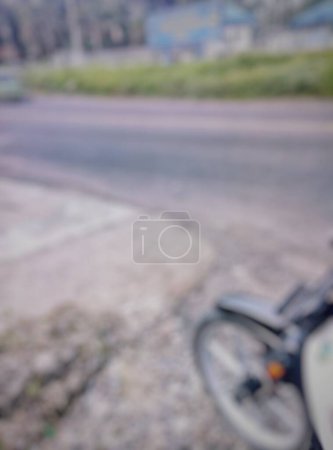 Bokeh. The front tire of a moped with a racing rim, when resting or stopping on the side of the road