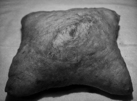 In the Java region of Indonesia, this is a very popular food. Odading or bolang-baling or kue bantal, fried bread, is a traditional Indonesian food. Monochrome, grey