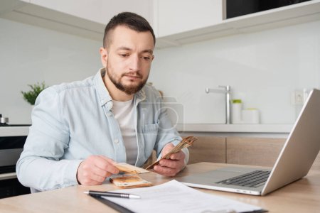 Photo for Business, finances, accounting and people concept - man with money and calculator filling papers at home. savings, economy and home - Royalty Free Image