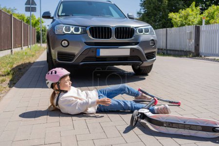 Photo for Accident, Small girl on the scooter is hit by the car. - Royalty Free Image