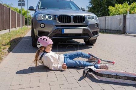 Photo for Accident, Small girl on the scooter is hit by the car. - Royalty Free Image