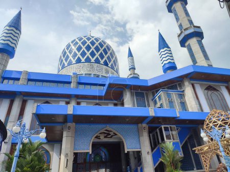 Photo for The blue dome of the mosque has a background of sky and clouds - Royalty Free Image