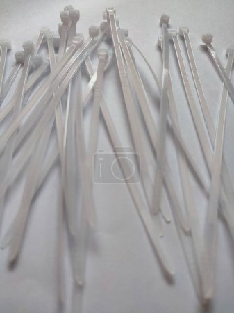 White plastic cable ties isolated on a white background