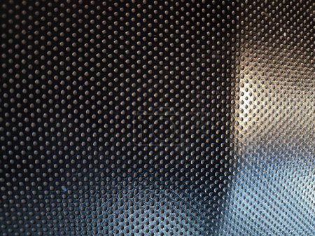 Black perforated polyurethane PU material texture for background