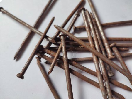 some scattered rusty nails on a white background