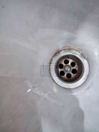 Metal sink drain isolated on white. Sink hole in the kitchen