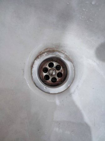 Desagüe del lavabo de metal aislado en blanco. Fregadero en la cocina