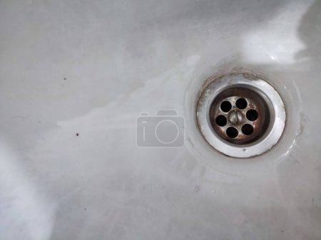 Metal sink drain isolated on white. Sink hole in the kitchen