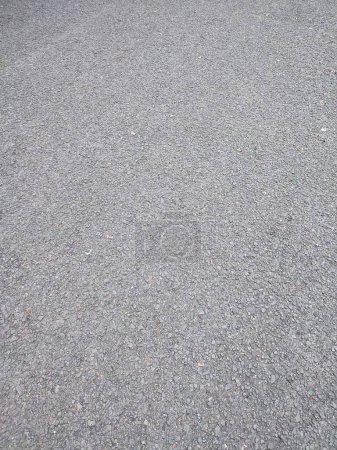 Foto de Asfalto áspero y rocoso grunge superficie, textura fondo, camino pavimentado gris - Imagen libre de derechos