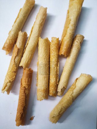 Kue semprong or Asian egg roll. This is a traditional Indonesian wafer or kuih snack isolated on a white background
