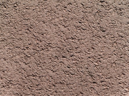 Photo for Uneven granular texture of dry compacted earth or sand of light gray-brown beige color - Royalty Free Image