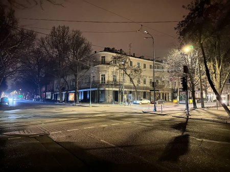 Photo for Odessa, Ukraine - 26 January 2023: Blackout in the Odessa Ukraine streets without street lighting only reflection color of traffic light and cars lights. - Royalty Free Image