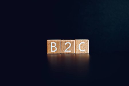 Wooden blocks form the text "B2C" against a black background.