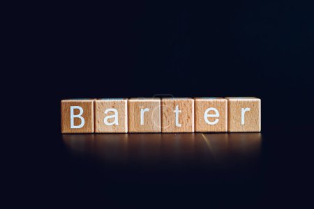Wooden blocks form the text "Barter" against a black background.