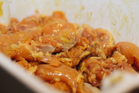 dish with raw chicken to prepare a tamale in the kitchen