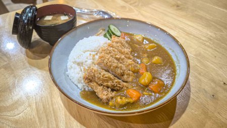 Japanese chicken katsu curry rice, deep fried breast chicken fillet with beef, carrot and potato curry