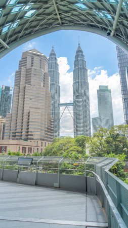 Photo for Twin Towers Petronas Towers View from the bridge The curved roof gives the image an edge. The sky is visible in the background. Buildings in Malaysia Mostly glass, looks modern - Royalty Free Image