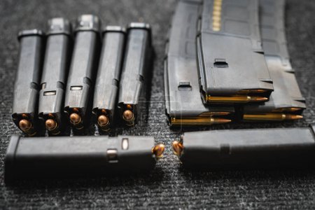 Photo for Pistol and rifle magazines with cartridges, close-up photo. High quality photo - Royalty Free Image
