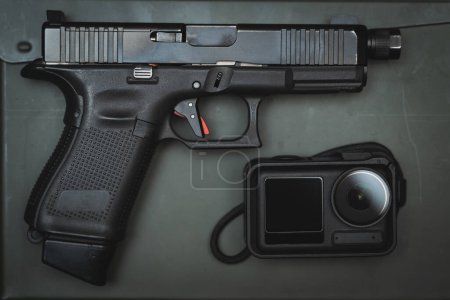 G19 pistol and action camera, close-up photo. High quality photo