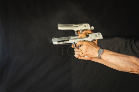 Shooting from a pistol, shot from a powerful desert Eagle weapon. High quality photo