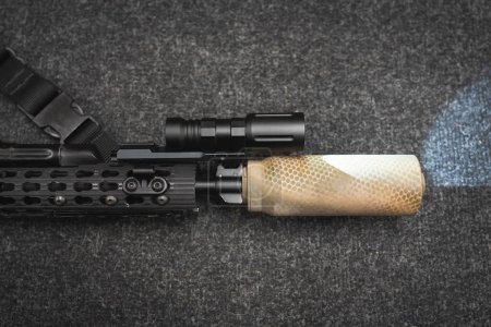 Photo for Tactical weapon, rifle with silencer and flashlight, close-up photo. High quality photo - Royalty Free Image