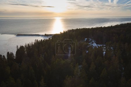 A pier and forest on the island of Aegna on a winter day, photo from a drone. High quality photo