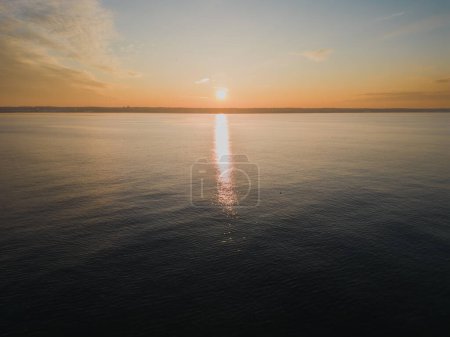 Drone photo of a sea sunset off the coast of Estonia in winter. High quality photo