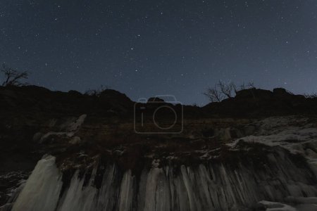 A cliff on the seashore in Paldiski in winter against the backdrop of the starry sky. High quality photo