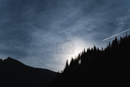 Polish Zakopane mountains with cable cars and forest illuminated by moonlight, photo at night in low light. High quality photo