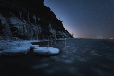 Night winter scene pf Estonian nature, view of the Paldiski sea cliff and the starry sky. High quality photo