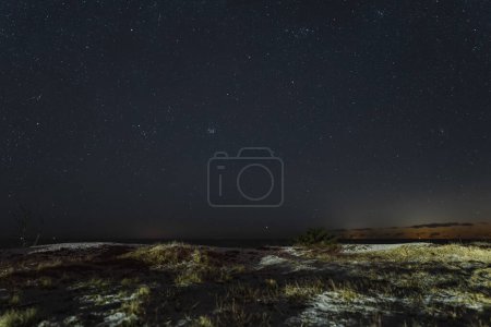 Starry night scene, view from the sea cliff of Paldiski peninsula in winter, landscape astrophotography. 