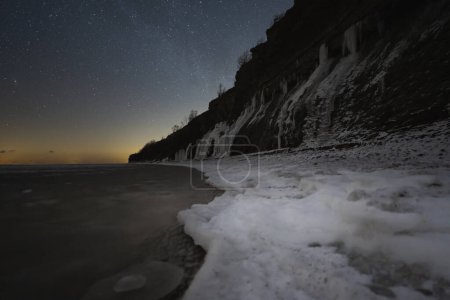 Landscape astrophotography. Night scene, Estonian nature, view of the Paldiski sea cliff and the starry sky. 