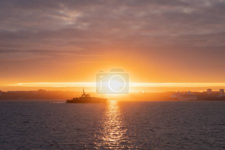 Photo for A military boat approaches Tallinn at dawn. - Royalty Free Image