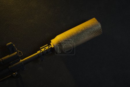 Photo for Tactical folding knife in camouflage color and rifle cartridges on a black background. - Royalty Free Image