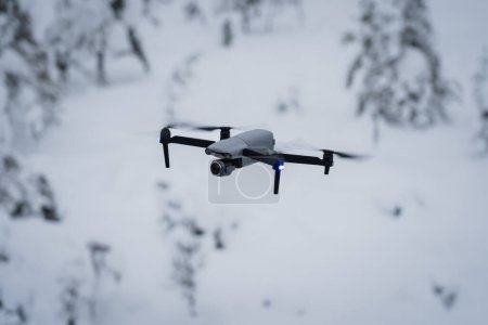 Photo for A drone with a camera in flight over a forest in winter. - Royalty Free Image