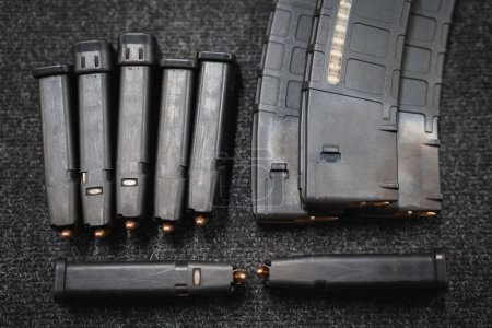 Loaded pistol and rifle magazines, close-up photo. 