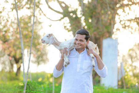 Photo for Happy Indian farmer, holding indian Goat - Royalty Free Image