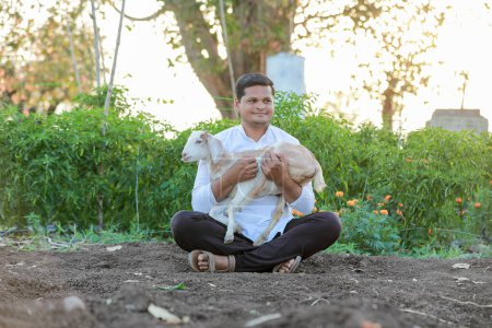 Photo for Happy Indian farmer, holding indian Goat - Royalty Free Image