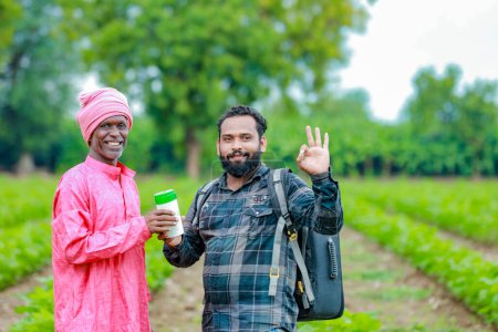 Photo for Indian farming. two farmer holding empty bottle in hands, farmer and agronomist - Royalty Free Image