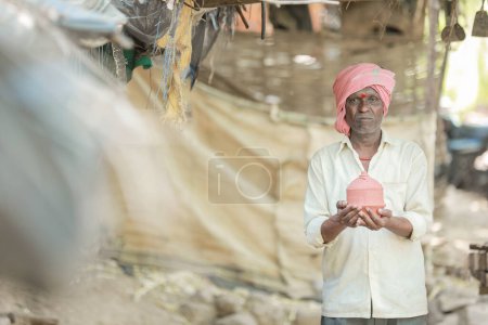 Photo for Farmer holding empty bottle in hands, happy indian farmer - Royalty Free Image