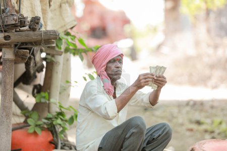 Photo for Rural Farmer Man Standing Field Showing Indian Currency Notes - Royalty Free Image